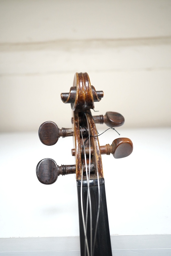 A cased violin, possibly German, body 35.5cm, in a good wooden case with canvas outer cover. Condition - fair